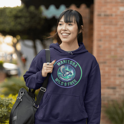 Embrace the magic of the prairies with our Manitoba – Wild & Free hoodie, featuring a captivating graphic of a snowy owl in flight beneath the shimmering northern lights.